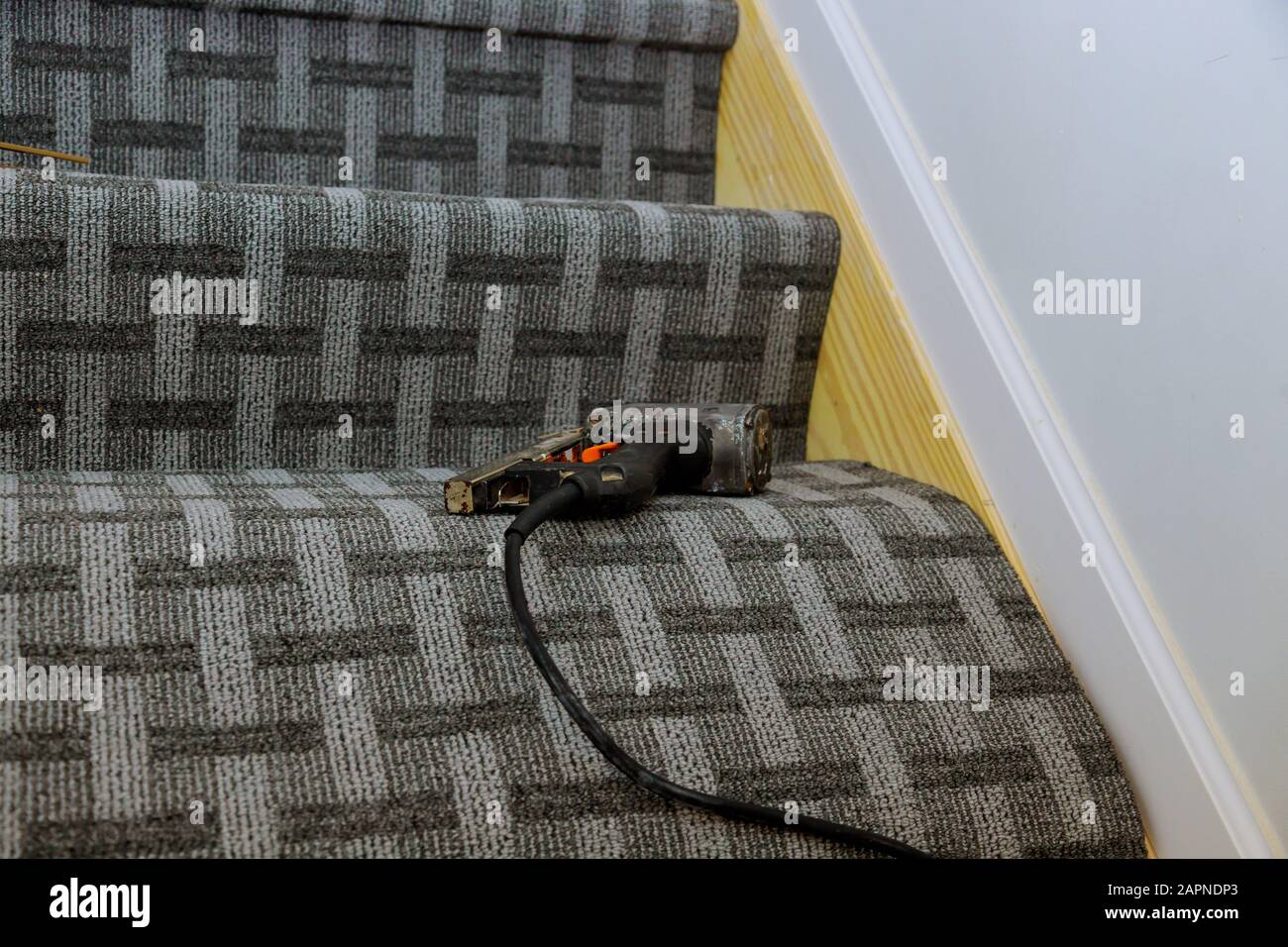 Installation out new carpet laying flooring in stairs Stock Photo
