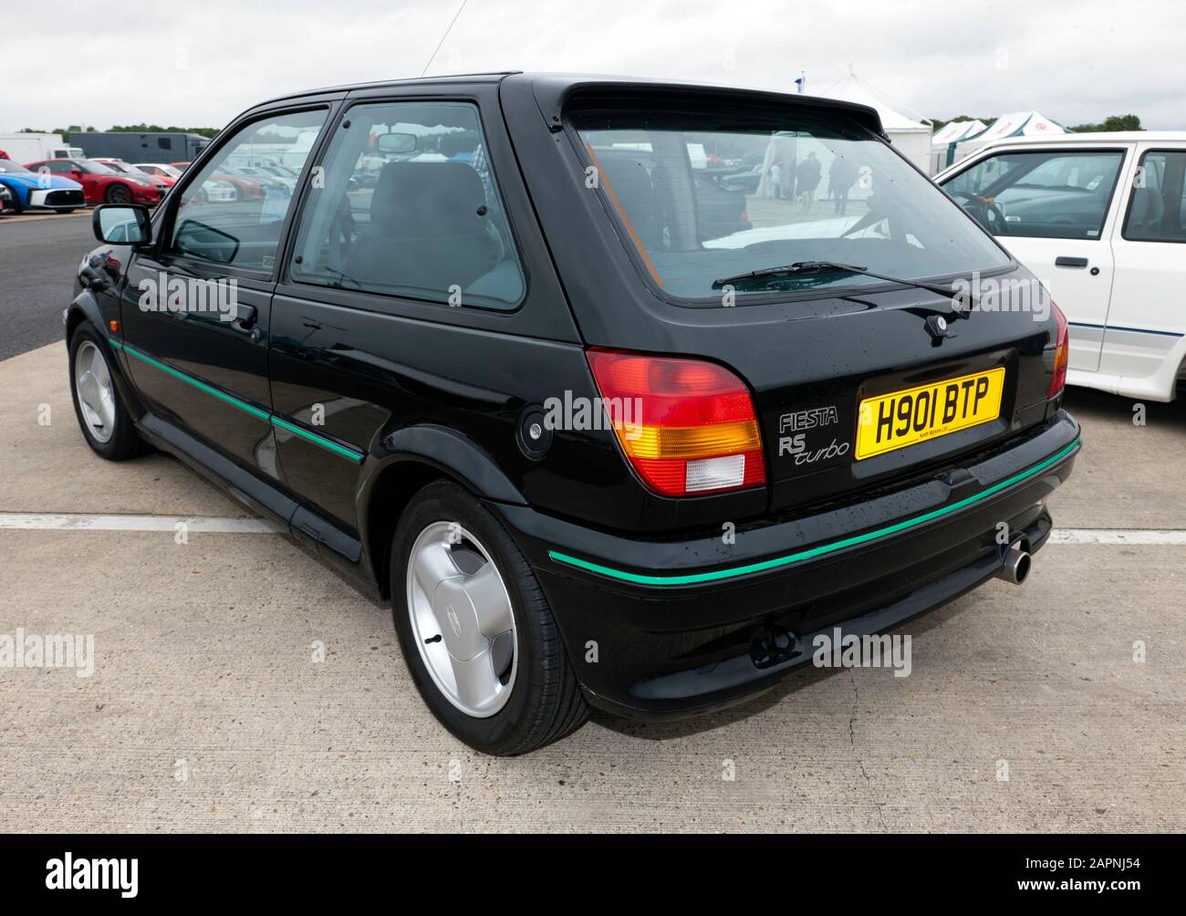 Three-quarter rear view of a Black, 1990, Ford Fiesta RS Turbo, on display at the 2019 Silverstone Classic Stock Photo