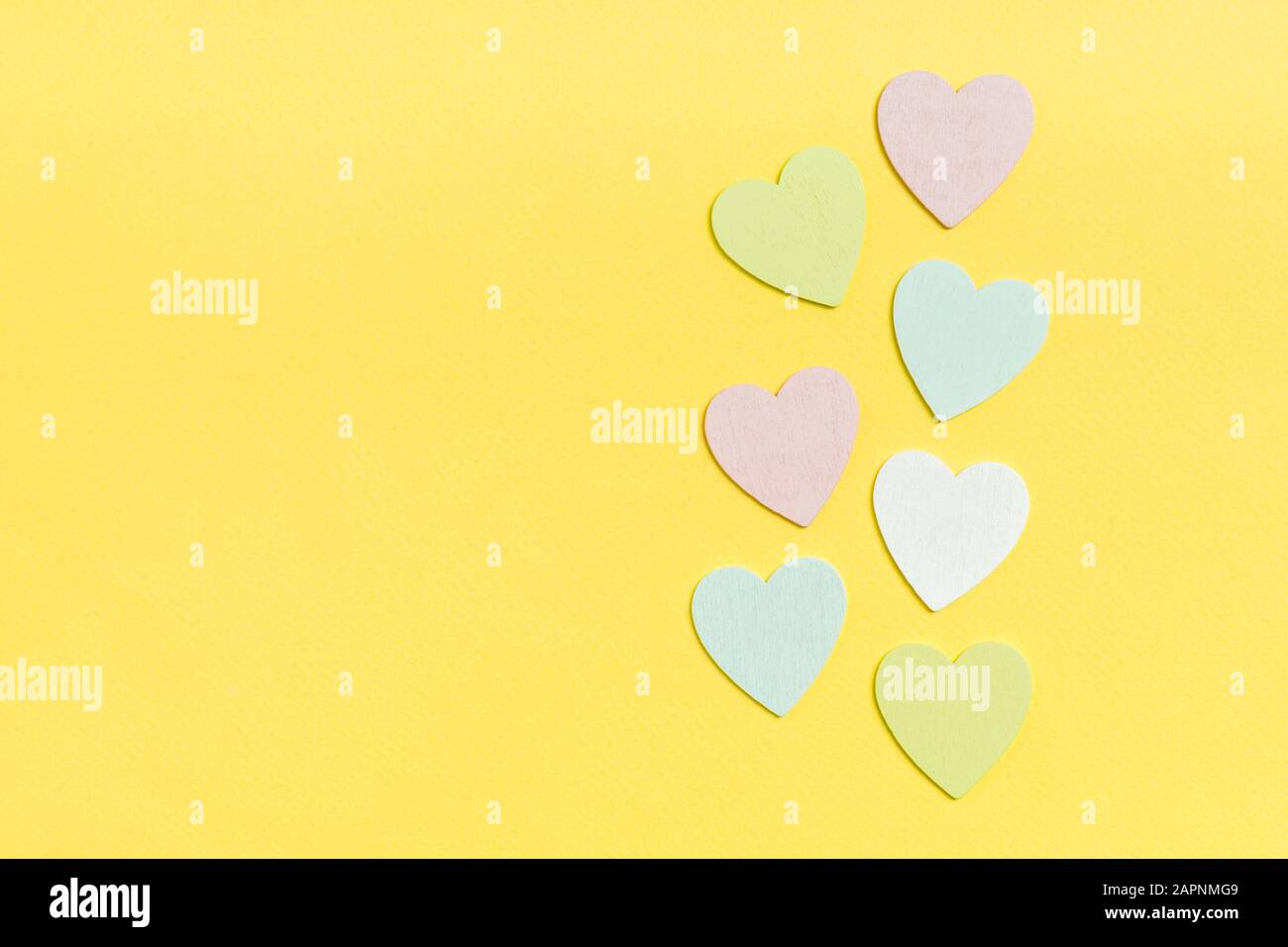 Top view composition of wooden hearts on colorful background. Romantic relationship concept. Valentaine's Day. Stock Photo