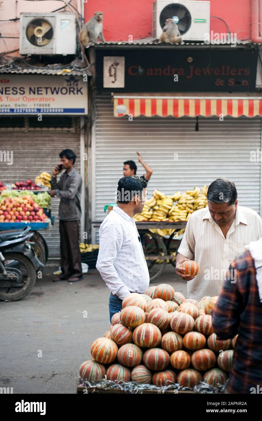 Fruit market at Chandni Chowk, Old Delhi, India on 5 April, 2018. Street vendors arrange fruits (melons, bananas, apples) on their four wheelers befor Stock Photo