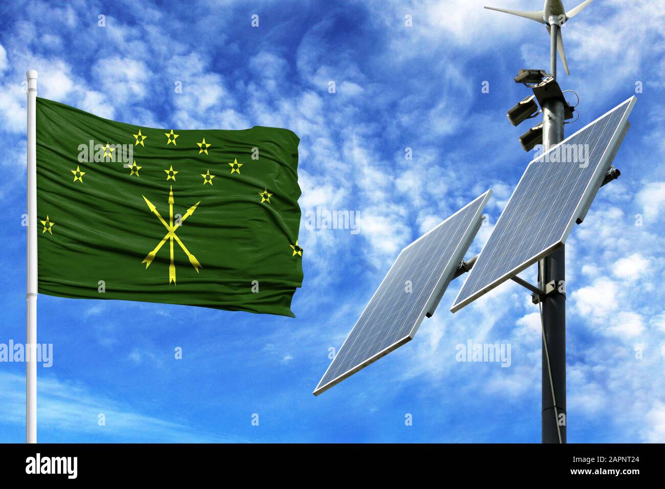 Solar panels on a background of blue sky with a flagpole and the flag of Adygea Stock Photo