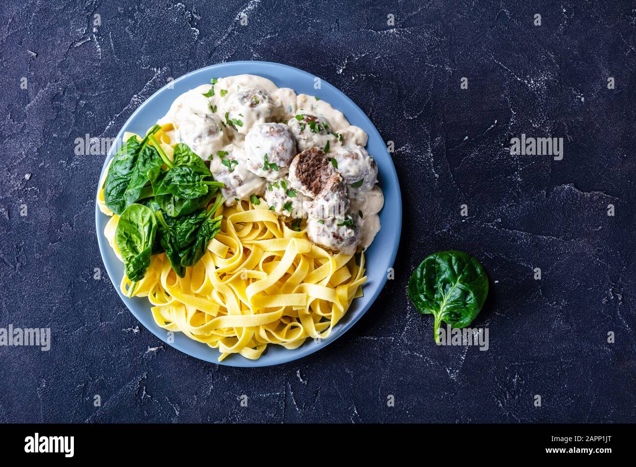 Swedish meatballs with egg noodle and spinach Stock Photo