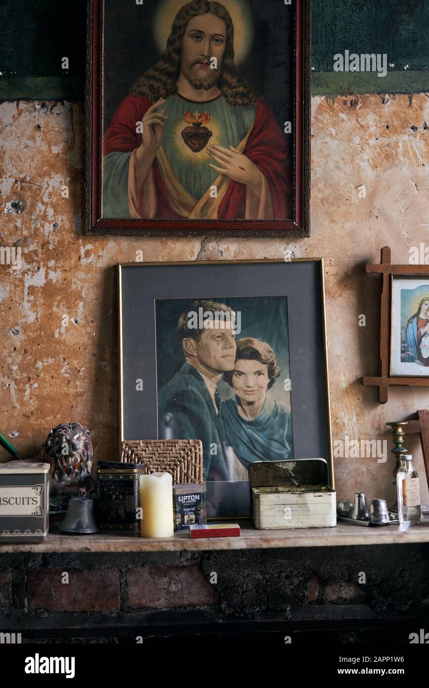A portrait of JFK and Jesus hangs above a fireplace in Dublin, Ireland. Stock Photo