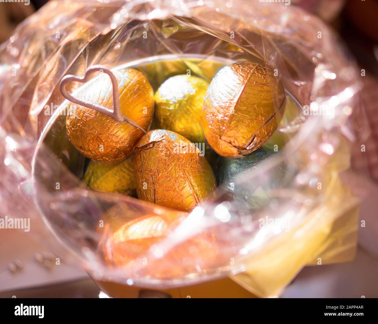 Easter eggs in an opened pink cellophane wrapping. A heart motif