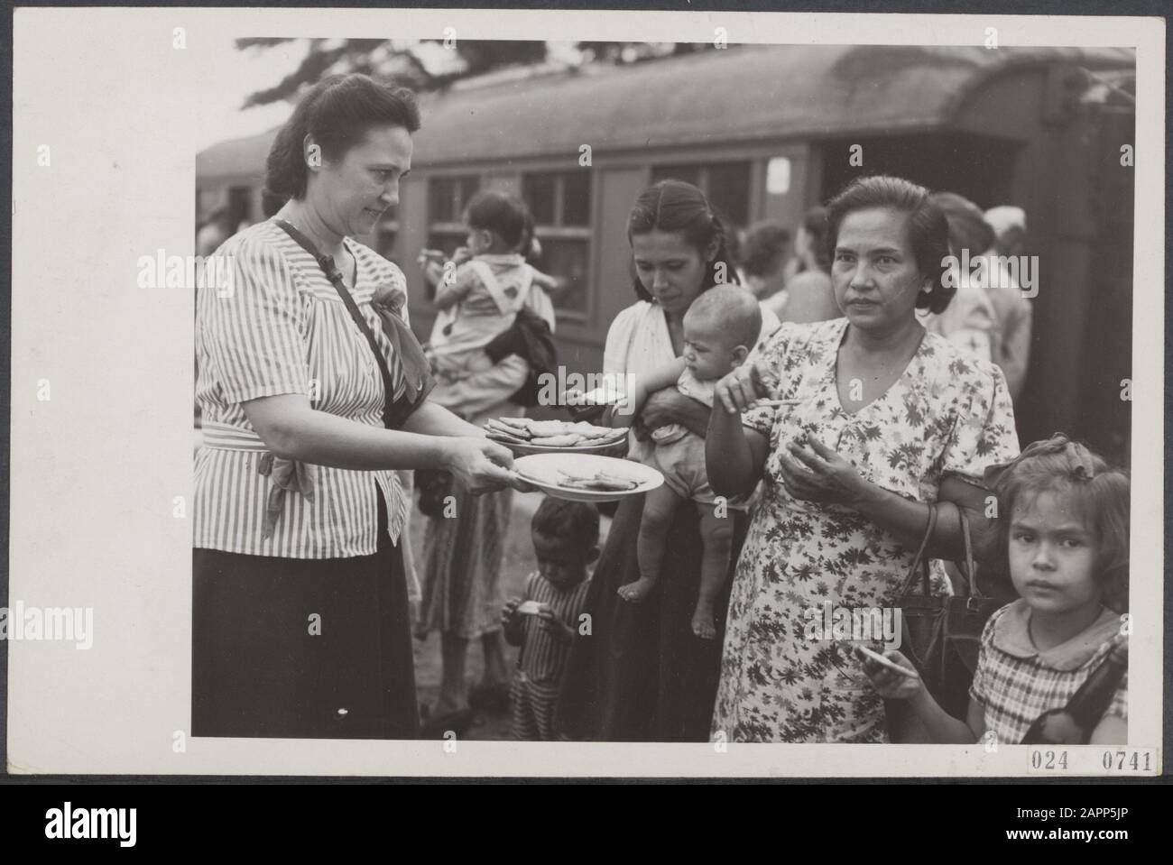 Red Cross United States distributes packages of coffee and milk to about 700 interned Europeans released by the Republic who arrived in Batavia by train Date: 26 April 1946 Location: Batavia, Indonesia, Indonesia, Jakarta, Dutch East Indies Keywords: help, victims Stock Photo