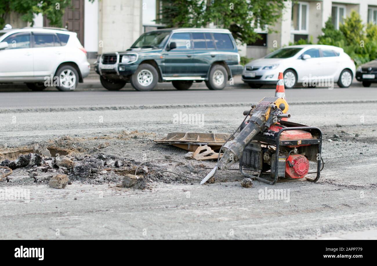 Pneumo electric jackhammer, which opened the surface of the asphalt. Russia. Stock Photo