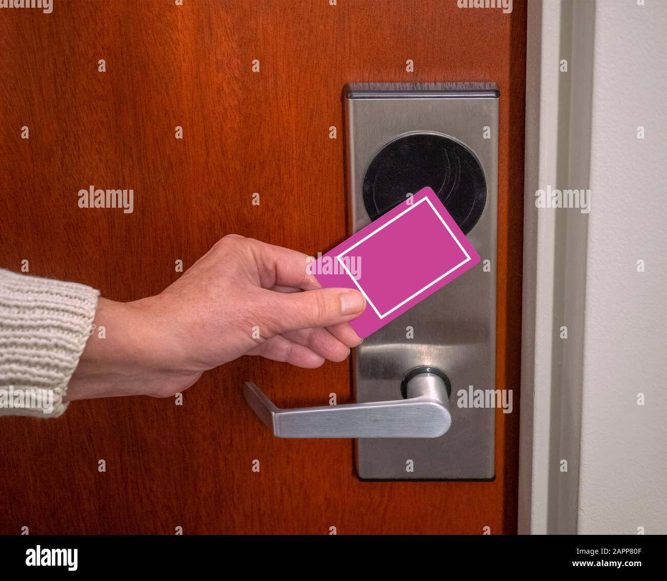 hand swiping key card to open hotel room door. Holding magnetic card for door access control swiping key card to lock and unlock door Stock Photo