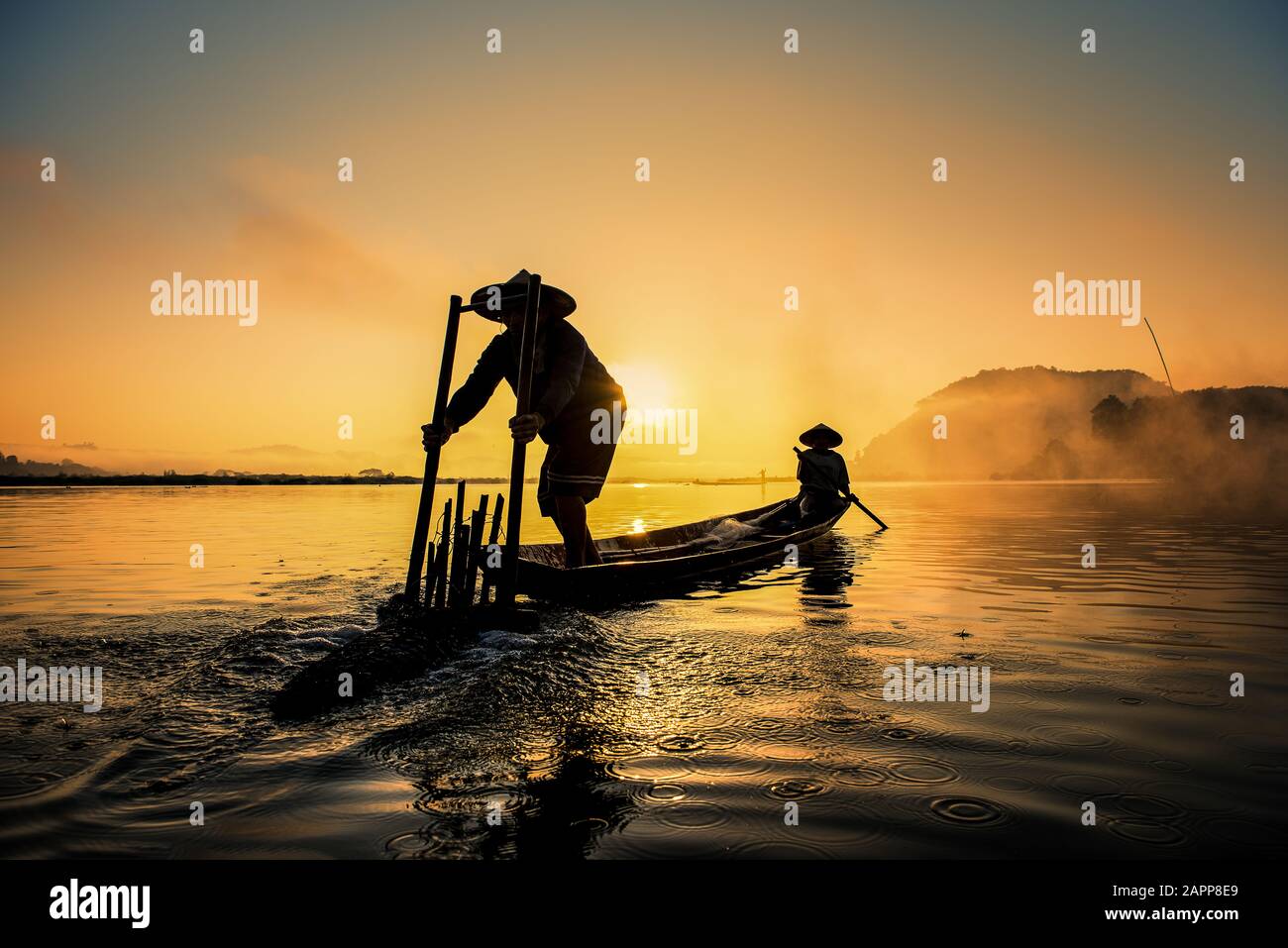 Asian Fishermen on boat fishing at lake, Thailand countryside Stock Photo