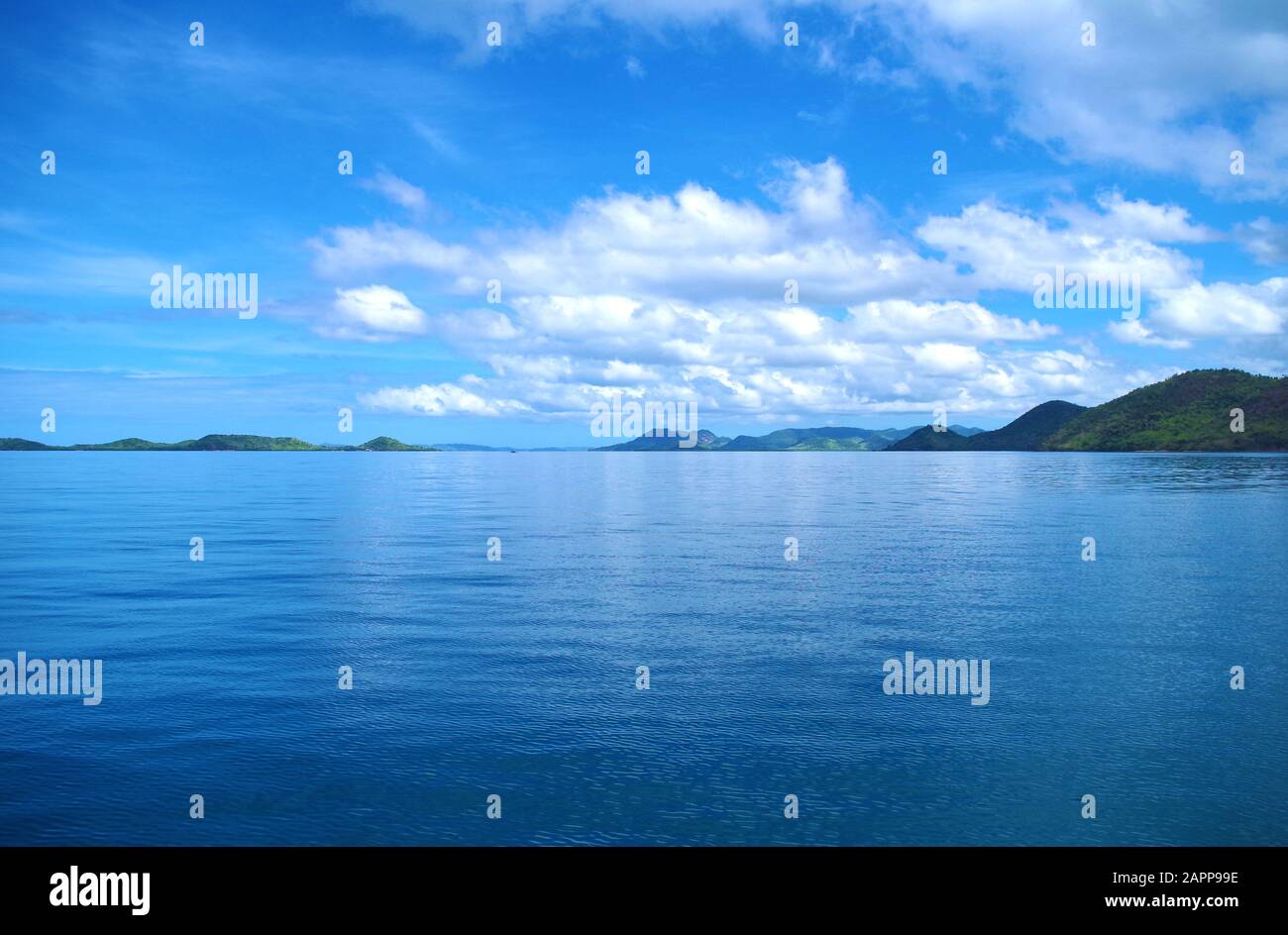 Forested islands in the Philippines archipelago. Isles are surrounded by the blue, calm waters of the ocean and azure, clear sky. Stock Photo