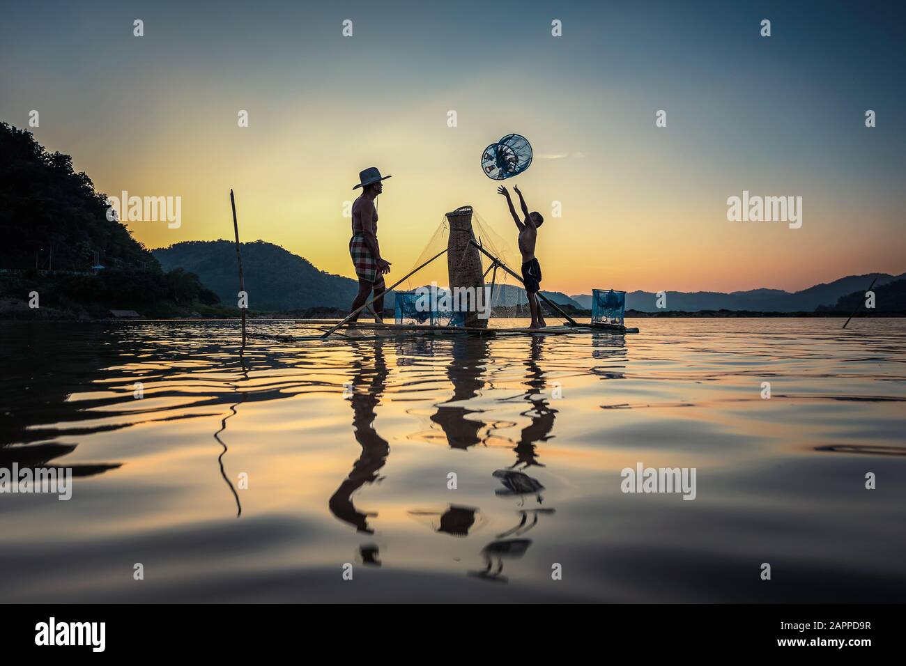 Silhouette father son fishing sunset hi-res stock photography and ...