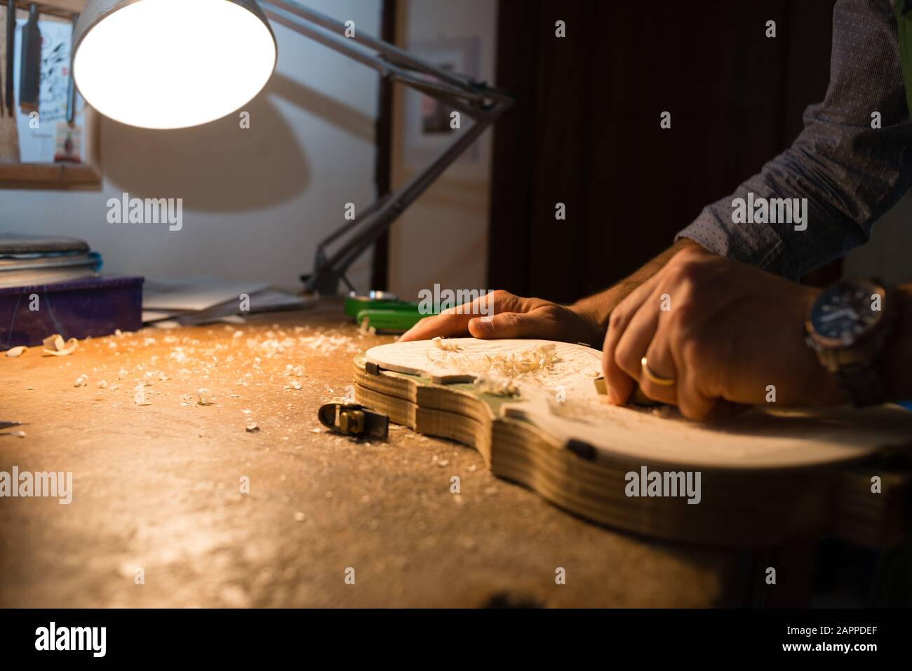 Violin maker at work in the laboratory with tools in Cremona Stock ...