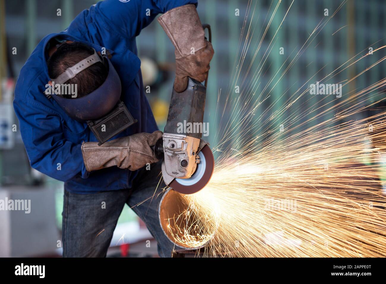 Electric wheel grinding on steel structure in factory Stock Photo Alamy