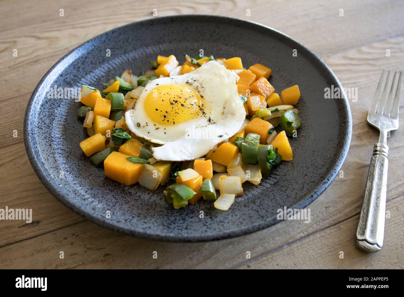 Butternut Squash Hash with a Fried Egg Stock Photo - Alamy