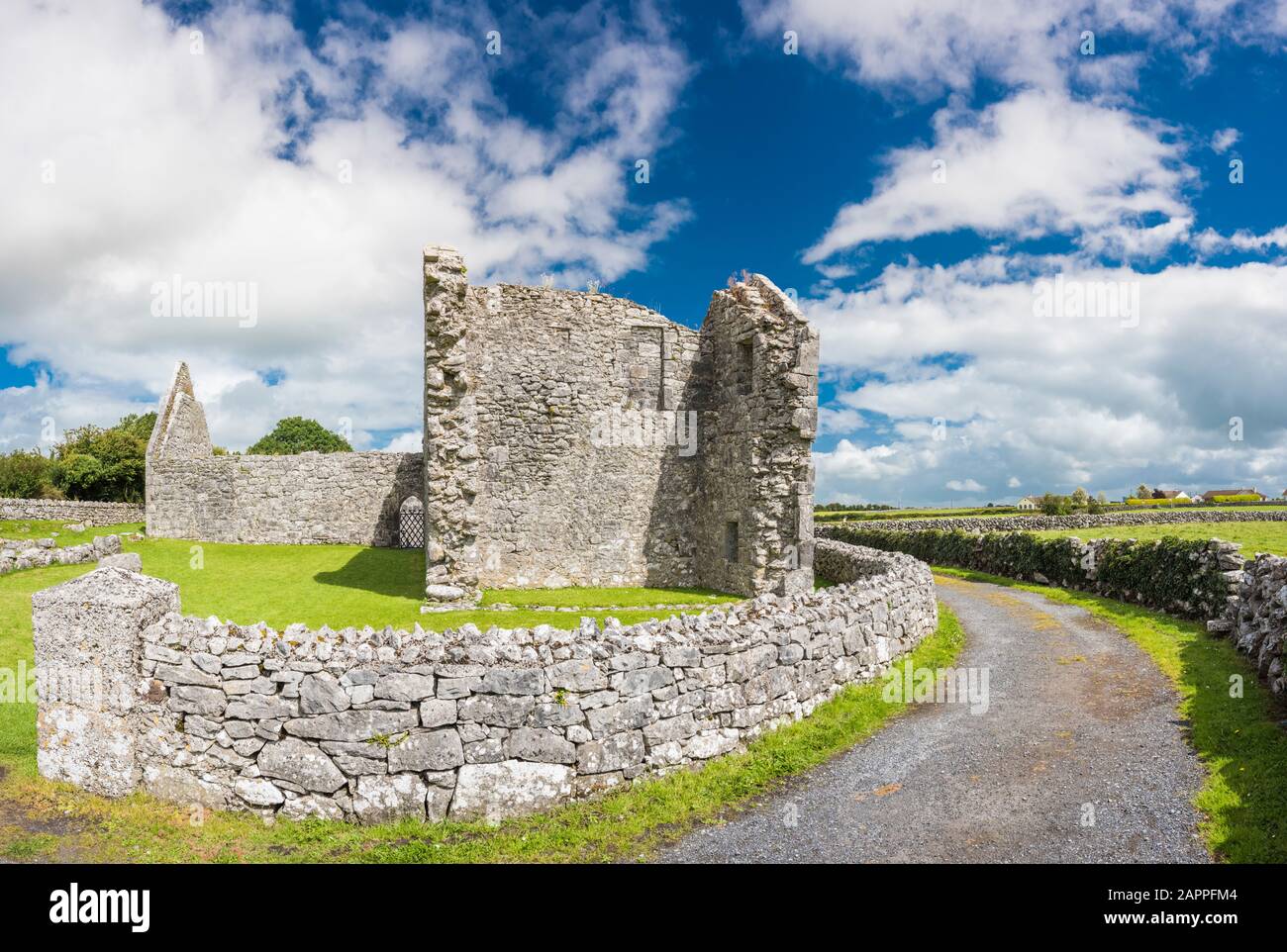 Ruined buildings and stone walls constucted from Carboniferous limestone at the 7th century Kilmacduagh monastery near Gort, County Galway, Ireland Stock Photo