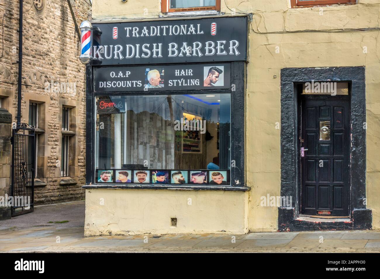 Traditional Kurdish barber shop on the corner of a street in the historic market town of Barnard Castle, Teesdale, County Durham, England, UK. Stock Photo