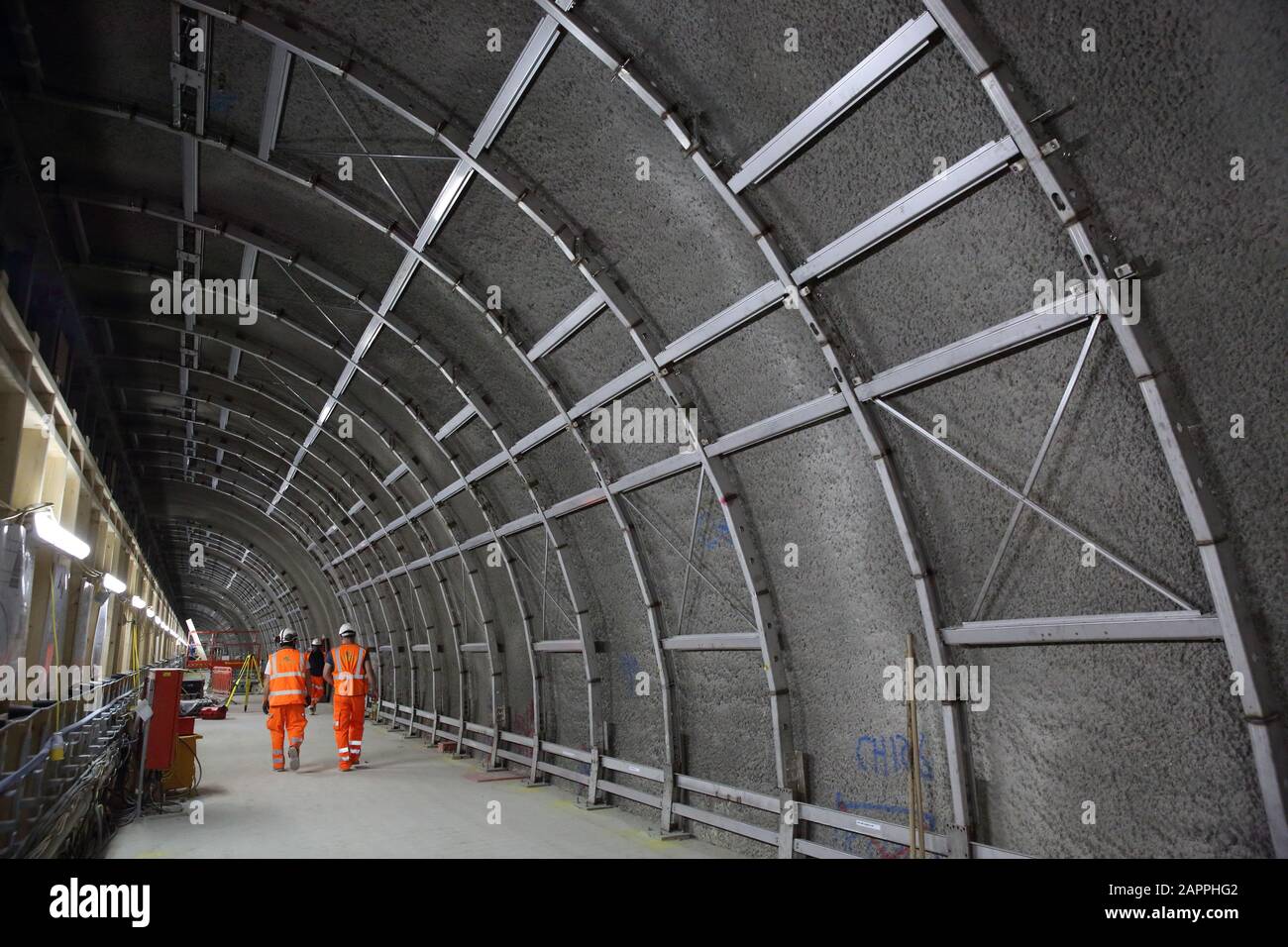 Engineers walk through Crossrail construction site tunnel at Tottenham