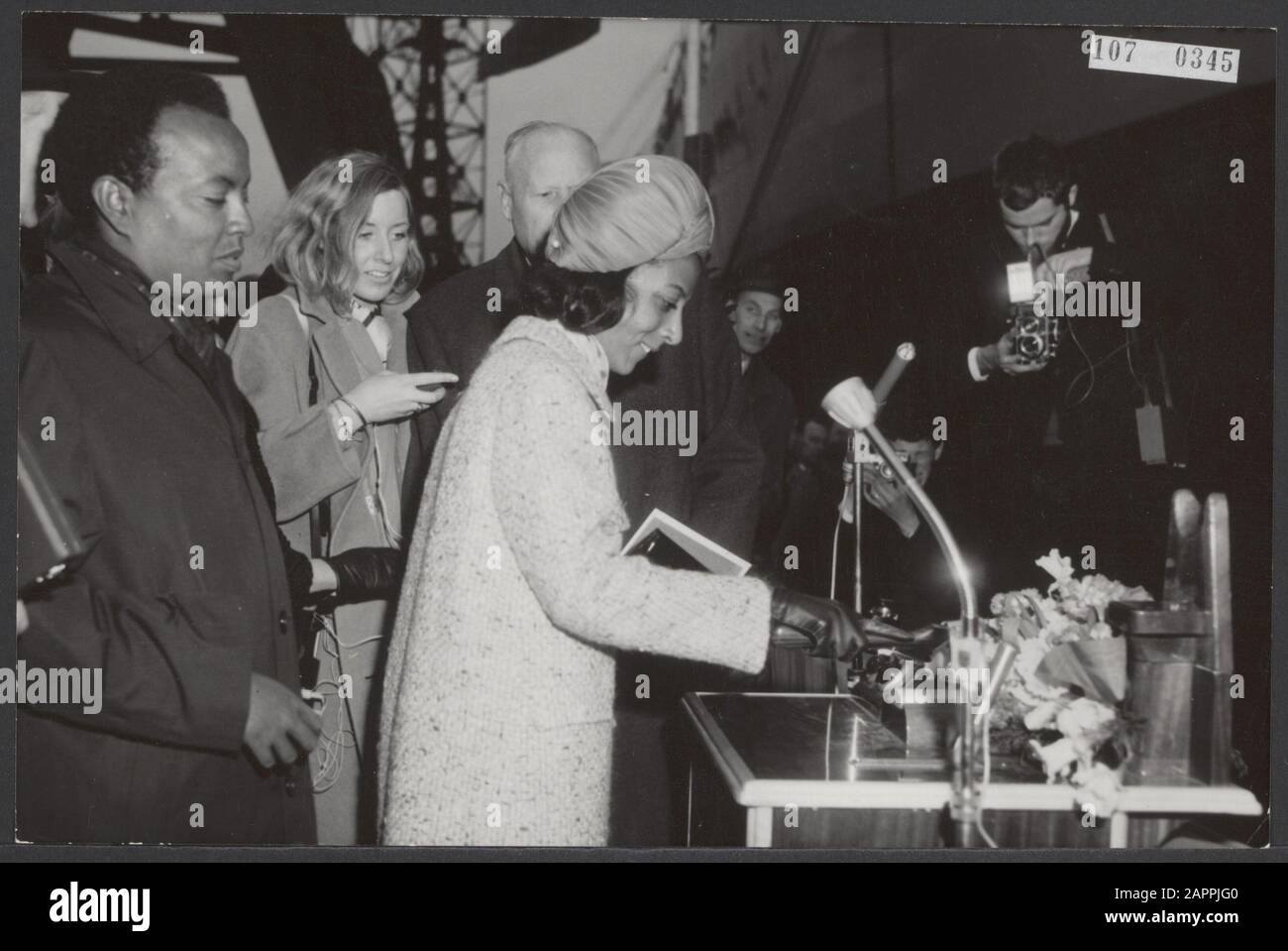 Princess Ruth Desta, the granddaughter of the emperor of Ehtiopia, performed at the yard of Verolme in Rozenburg the baptism of the 33,000 ton measuring motor tanker Lalibela. The tanker was built on behalf of Ethiopian Shipping Lines in Addis Ababa. With an axe the princess chops the line through which the champagne fels hit the ship wall. Completely left Alexander Desta, grandson of the Emperor Date: 1 April 1966 Location: Ethiopia, Rozenburg Keywords: baptisms, shipbuilding, shipyards, ships, tankers Personal name: Desta Alexander, Desta Ruth, Ethiopian Shipping Lines Institution name: Lali Stock Photo