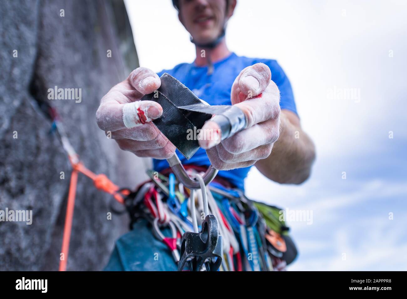 Climber taping bleeding finger, trad climbing, Stawamus Chief, Squamish, British Columbia, Canada Stock Photo