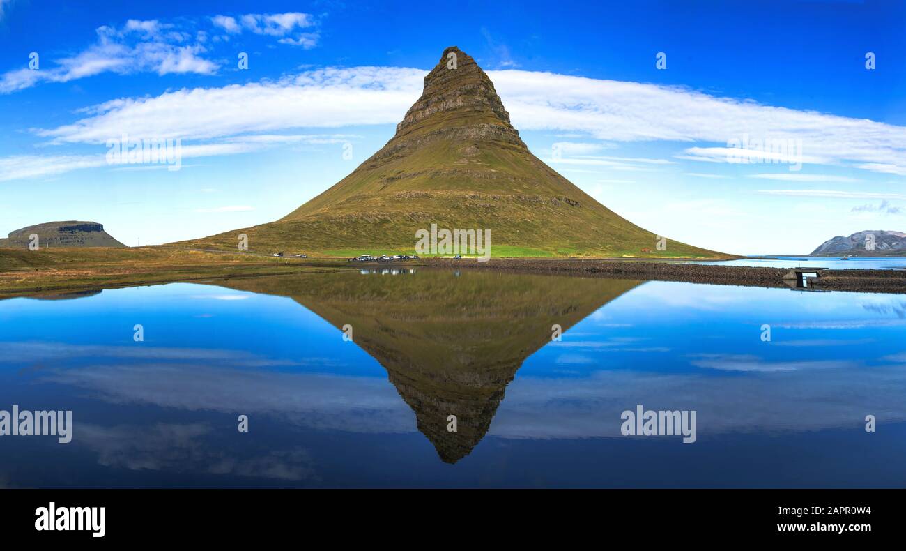 Summer sunset over the famous Kirkjufellsfoss Waterfall with Kirkjufell mountain in the background in Iceland. Long exposure. Stock Photo