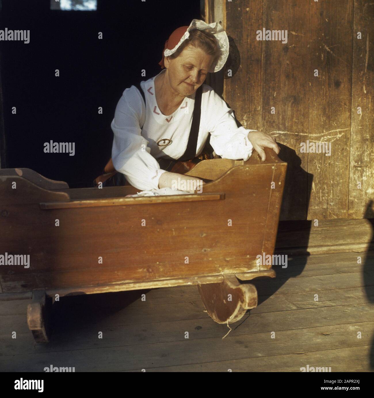 Old woman at wooden crib Date undated Stock Photo Alamy