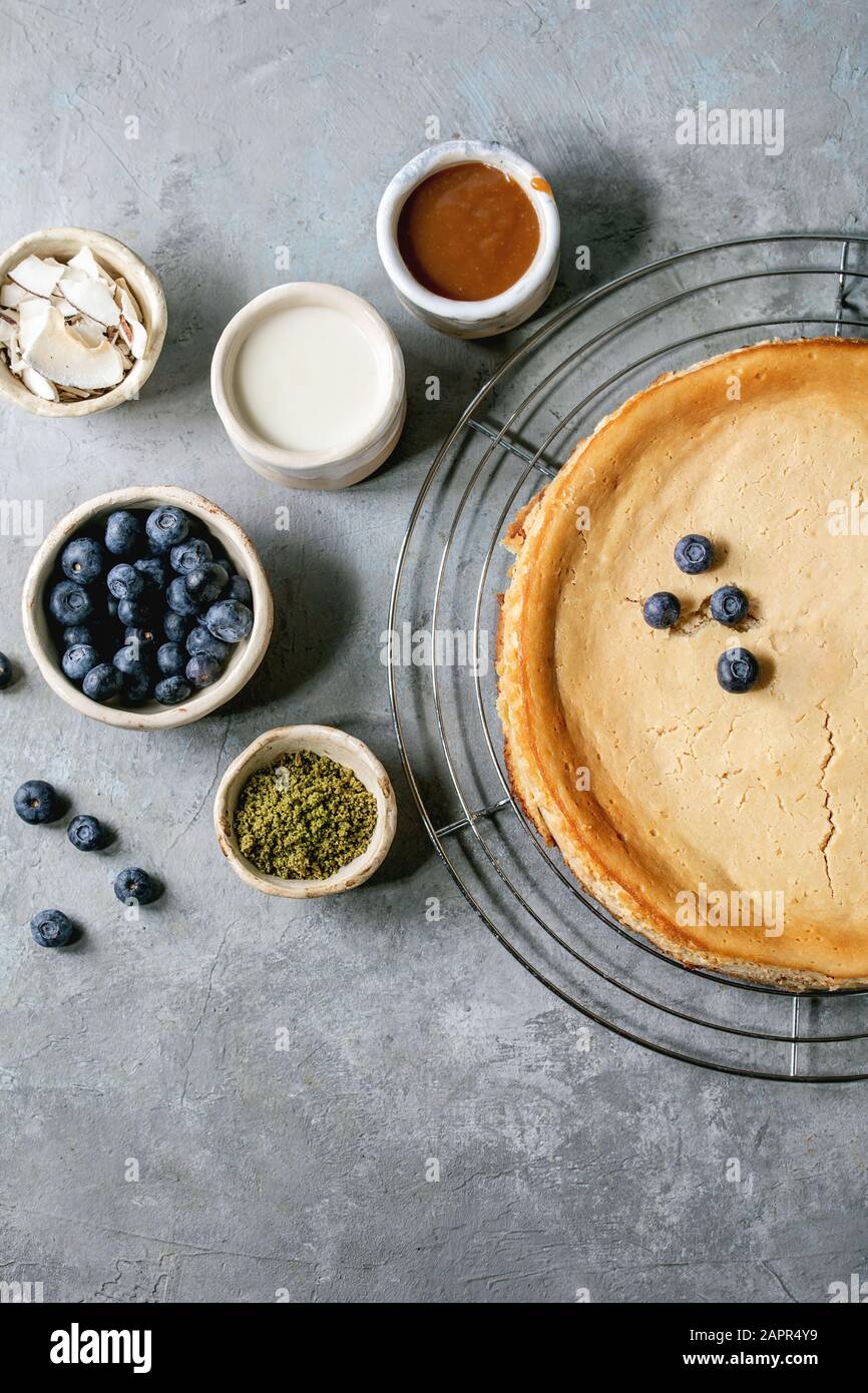 Homemade cane sugar baked cheesecake on cooling rack with variety of