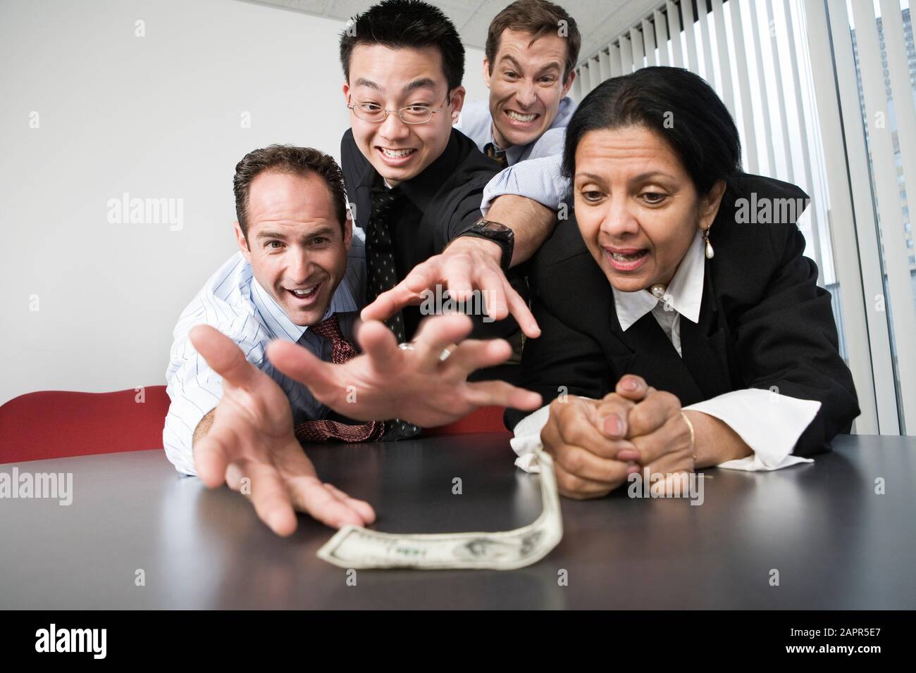 View of businesspeople grabbing a dollar bill Stock Photo Alamy