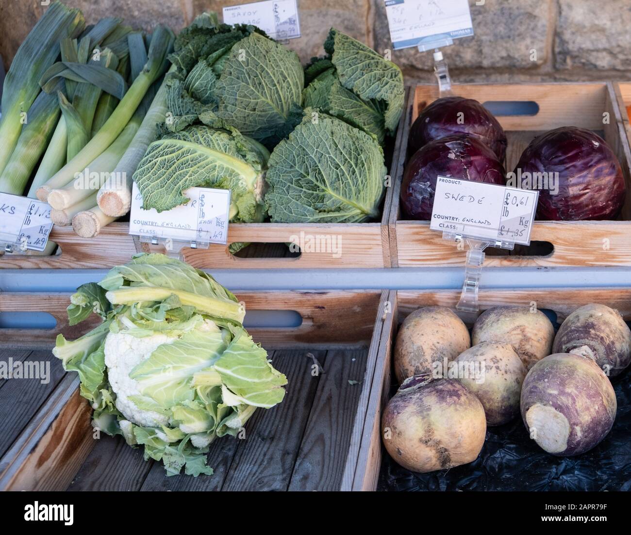Local english grown vegetables at a farm shop, winter vegetables leeks, cauliflower, cabbage and swede Stock Photo