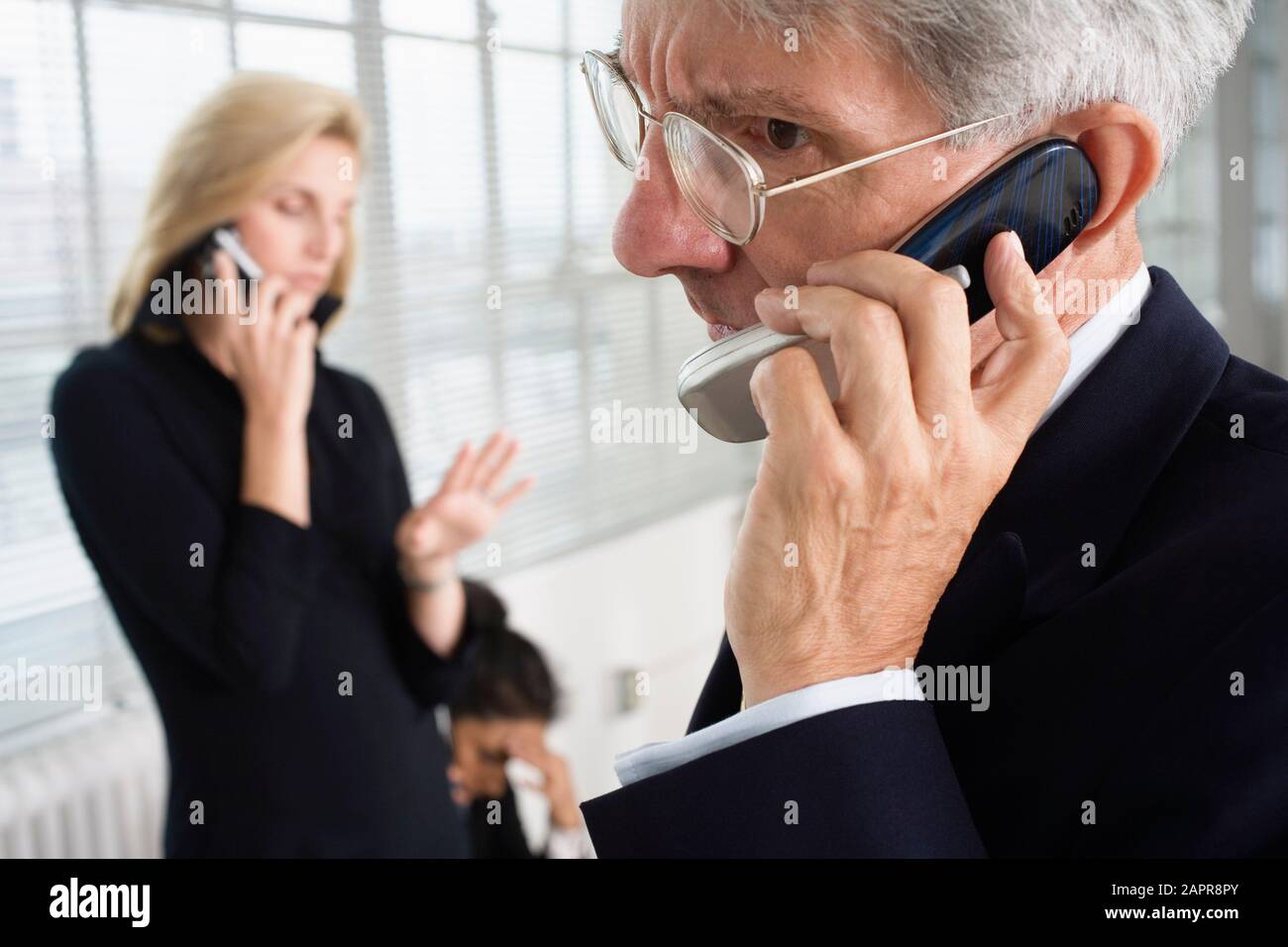 Businesspeople using cellphone. Stock Photo