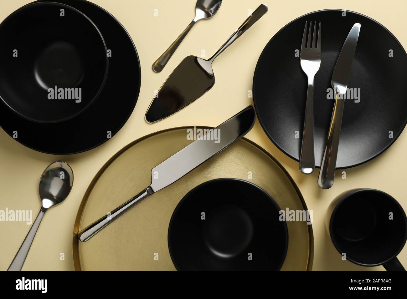 Tableware and cutlery on beige background, top view Stock Photo
