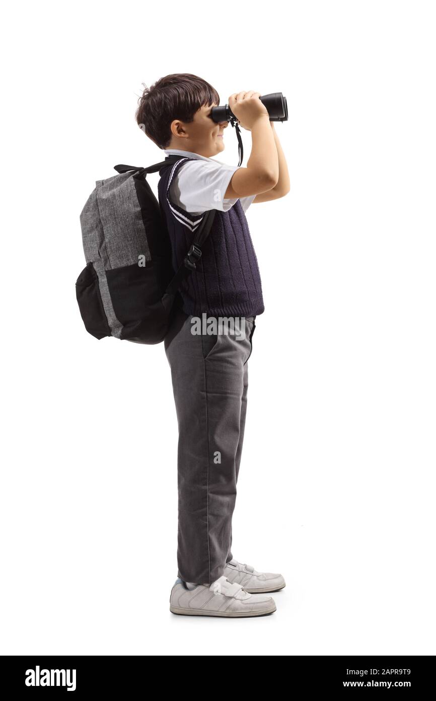 Full length profile shot of a schoolboy with a backpack looking through ...