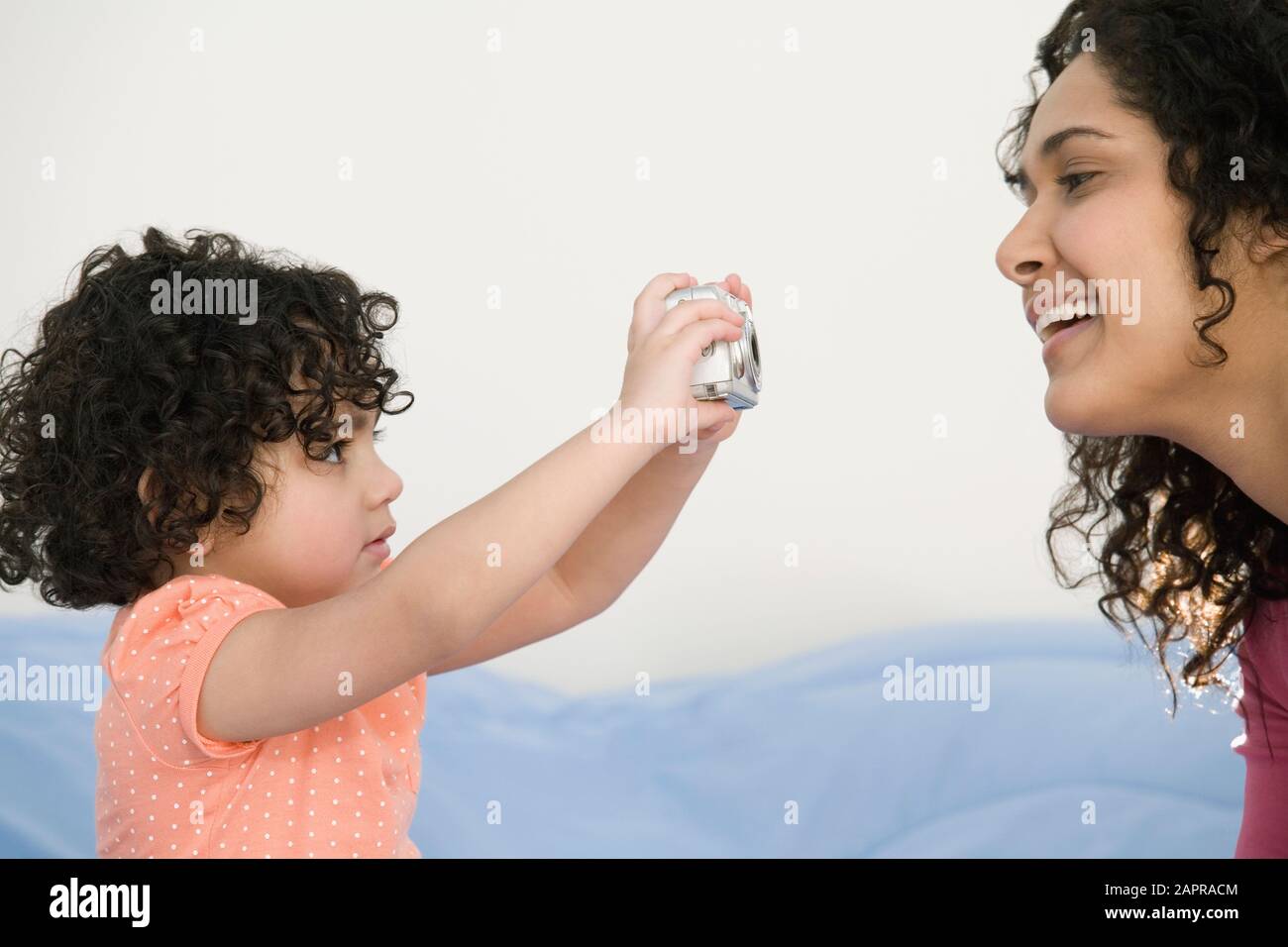 Close-up of a girl taking a picture of her mother with a digital camera Stock Photo