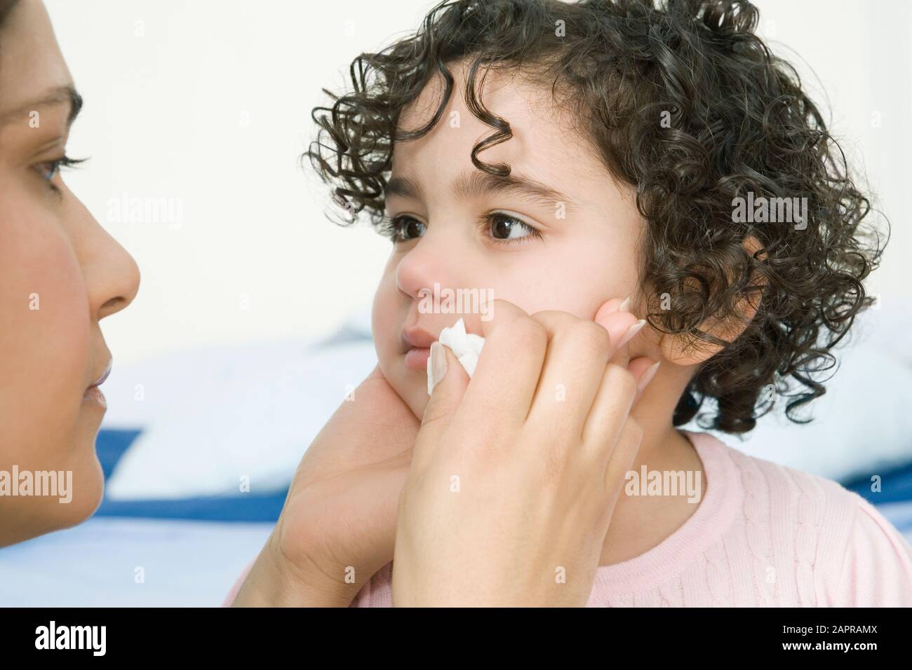 Mother wiping childs tears Stock Photo
