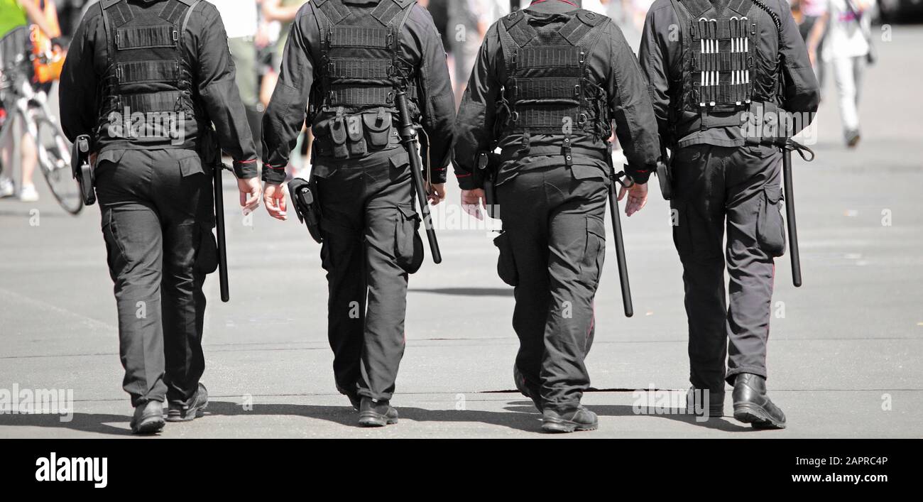four policemen in riot gear during a demonstration Stock Photo - Alamy