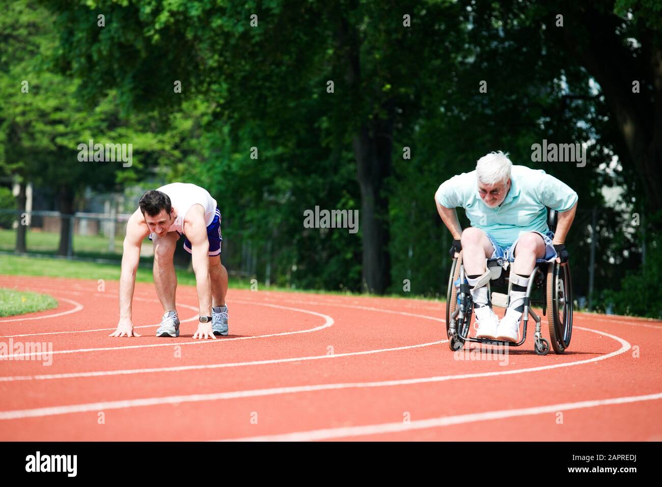 Young man racing with a handicapped senior man on a racetrack Stock ...
