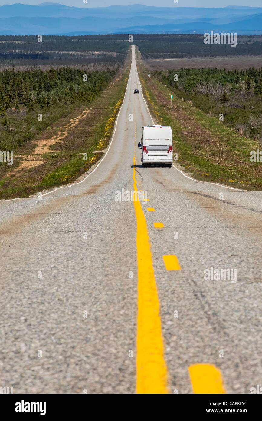 A tour bus travels along a long, lonely stretch of highway between Delta Junction and Paxson, Alaska. Milepost 248, Old Richarson Highway Stock Photo