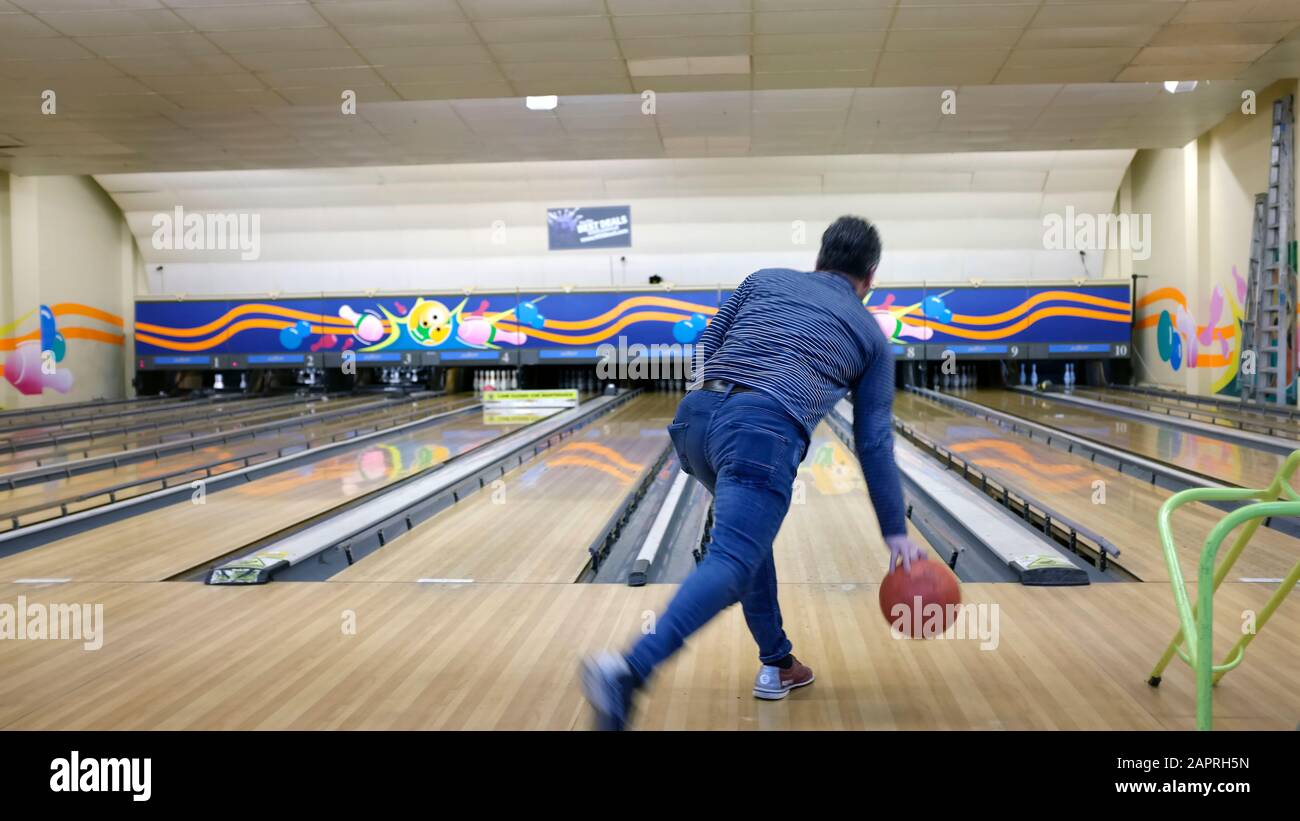 Man bowling at a ten pin bowling alley. Stock Photo