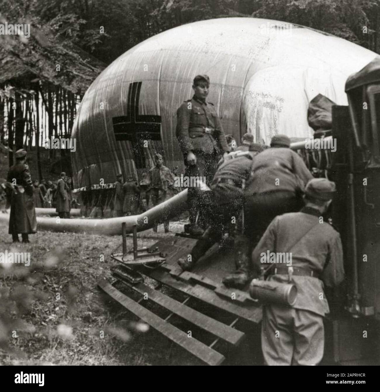 World War II: German soldiers prepare lookout balloon in a forest. Place unknown, 1939. Stock Photo