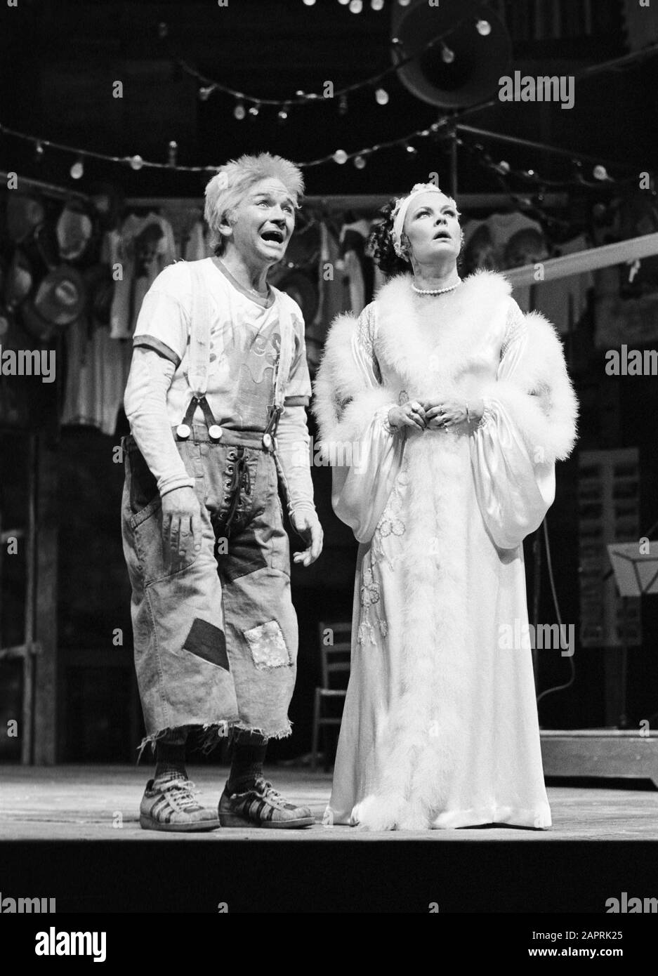 Michael Williams (as Dromio of Syracuse) and Judi Dench (as Adriana) in THE COMEDY OF ERRORS by Shakespeare designed by John Napier with musical staging by Gillian Lynne and directed by Trevor Nunn. A 1976 Royal Shakespeare Company (RSC) production in Stratford-upon-Avon, England. Dame Judith Olivia Dench CH DBE FRSA, born 1934. Married to the actor Michael Williams from 1971 until his death in 2001. They had one daughter, the actress Finty Williams, born in 1972. Stock Photo