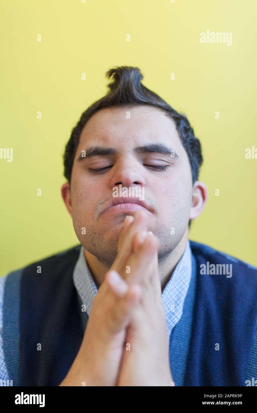 Middle Eastern man with Down Syndrome thinking Stock Photo