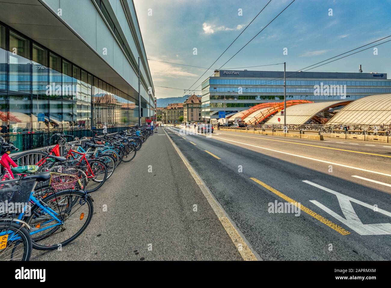 Bern, Switzerland - July 26, 2019: many bicycles parked in the street near the main train station and Post office in the capital of Switzerland.. Stock Photo