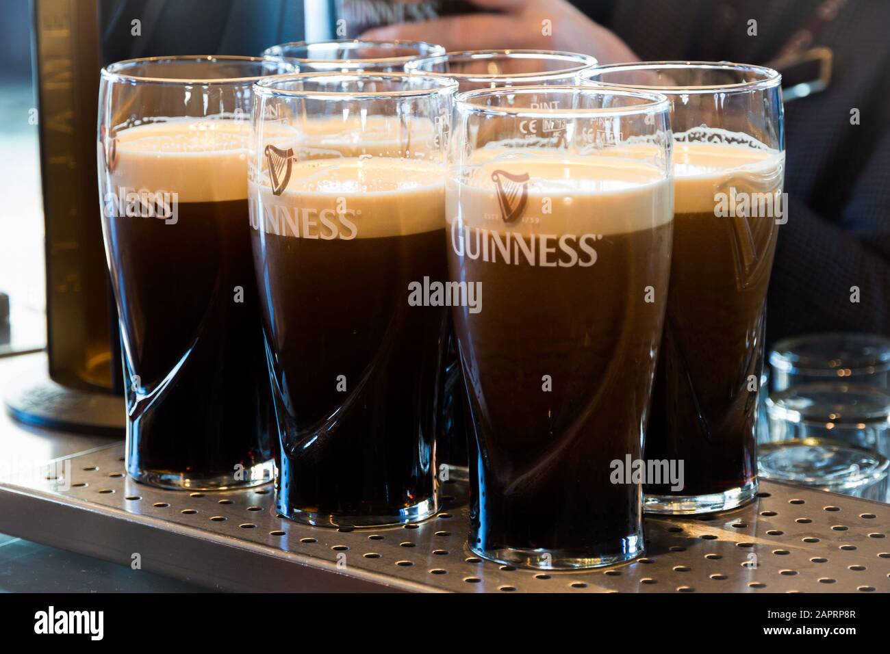 DUBLIN, IRELAND - FEB 15, 2014: Pints of Guinness are being served in a pub in Dublin, Ireland Stock Photo