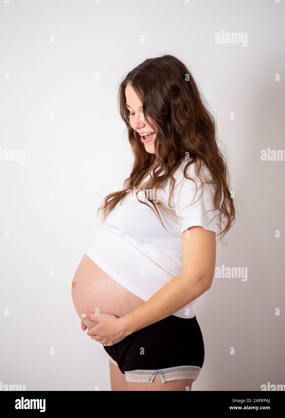 The Young Beautiful Pregnant Woman Experiences Strong Emotions On A White Background Stock Photo Alamy