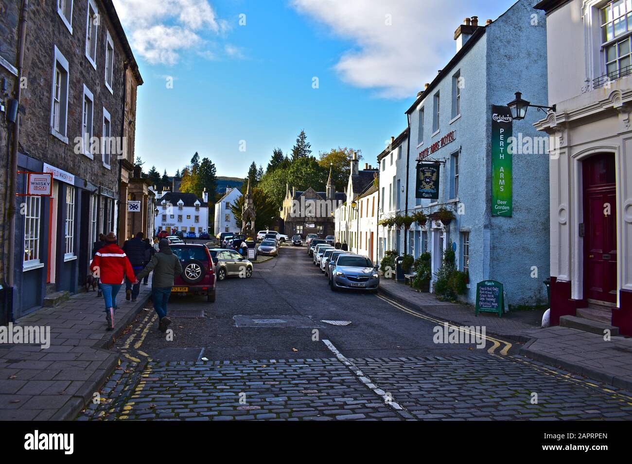 A general view of the old houses, shops & hotels that line the High Street in the centre of Dunkeld.The Atholl Memorial Fountain is in the distance. Stock Photo