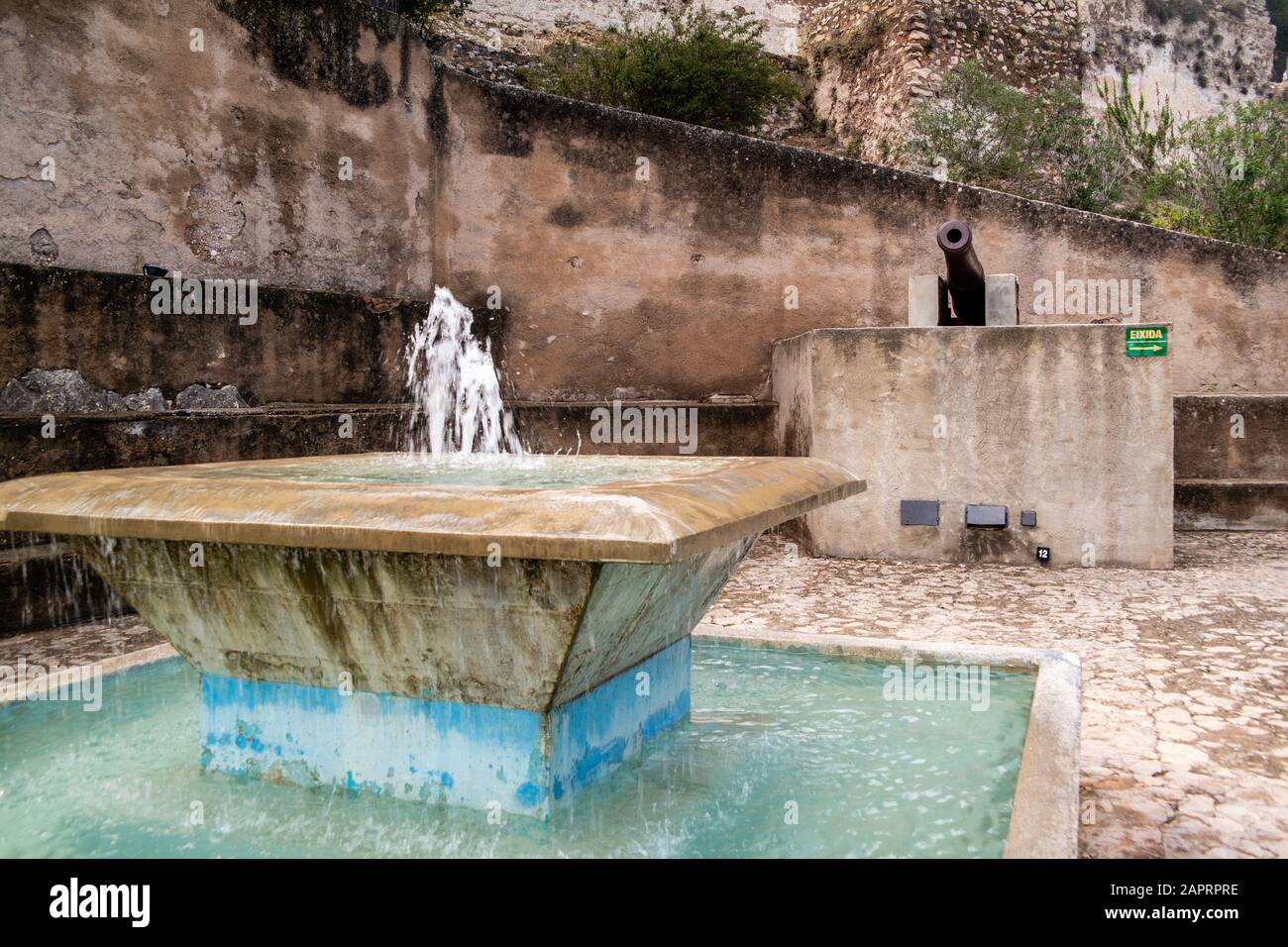 Beautiful shot of a water fountain with cannon in the background in