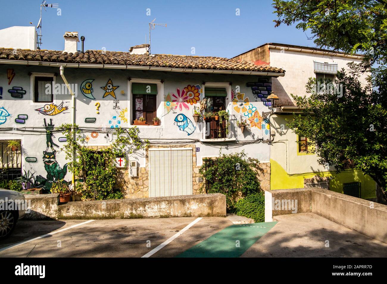 Beautiful shot of a white building in Xativa, Spain covered with colorful doodles Stock Photo