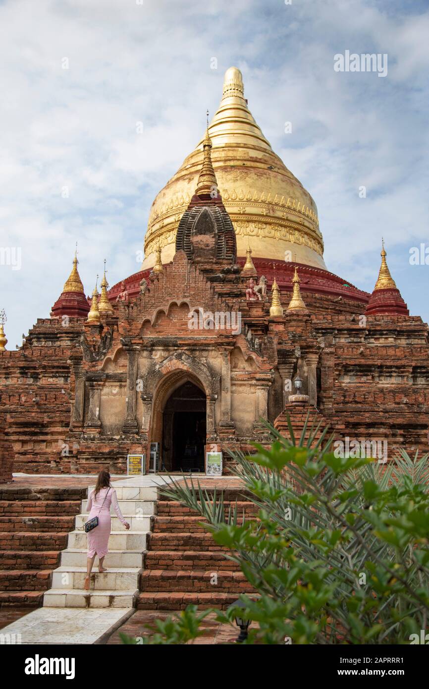 One woman visiting the Shwezigon Temple during a cloudy day, Bagan Stock Photo