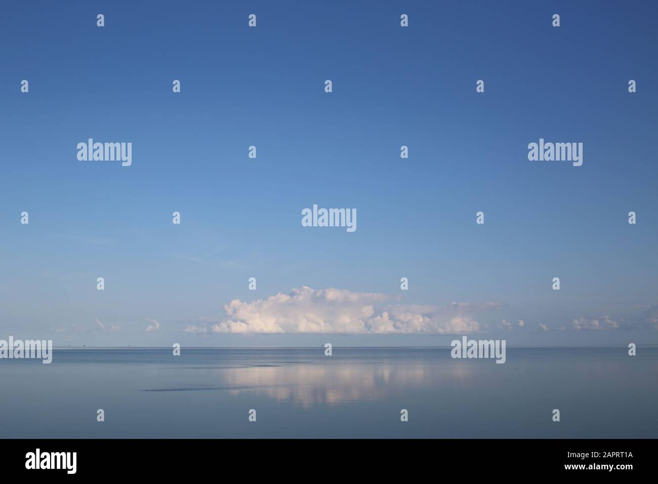 Calm Ocean Sound With Low Clouds On A Clear Morning Stock Photo