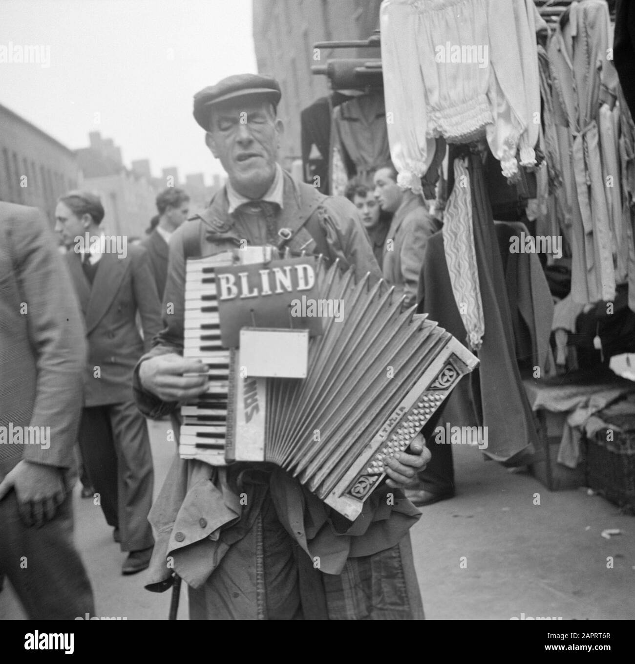 Market in Petticoat Lane, London A blind accordion player Date 1947