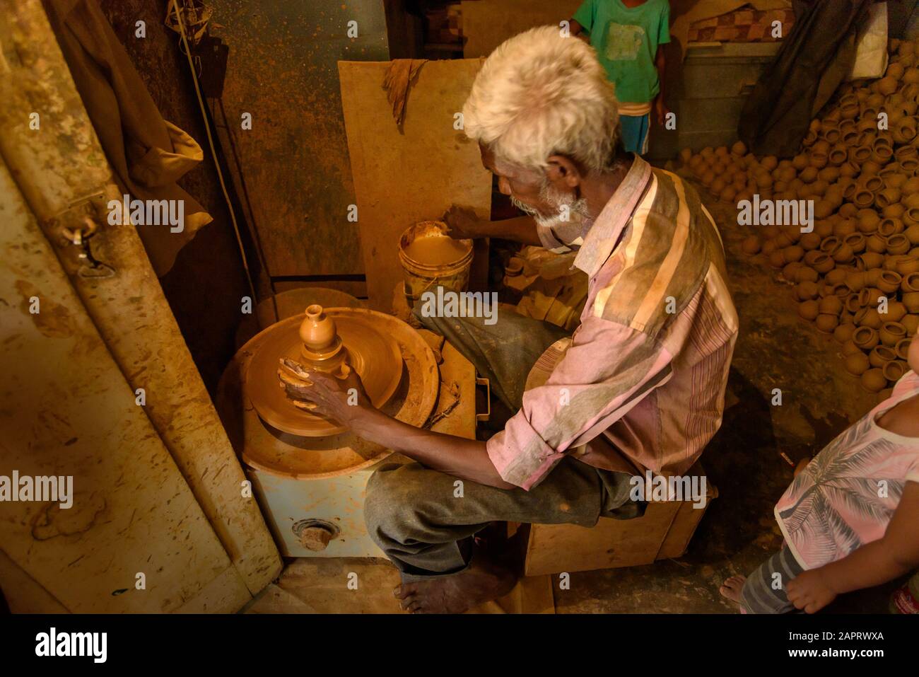 Indian potter making clay pots on pottery wheel in Pottery town is old