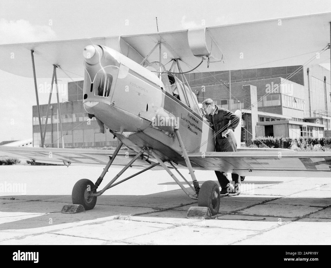 National Aviation School Holland  A mechanic talks to the adspirant pilot of the Koolhoven-FK 46 class plane nicknamed 'Cow of Koebeest' because of his docile flying behaviour of the National Aviation School Holland Amsterdam Schiphol Annotation: The National Aviation School Holland was based in Rotterdam Waalhaven and Amsterdam Schiphol Date: 1933 Location: Amsterdam, Rotterdam Keywords: pupils, mechanics, pilots, flight training, aircraft Personname: Frits Koolhoven Stock Photo